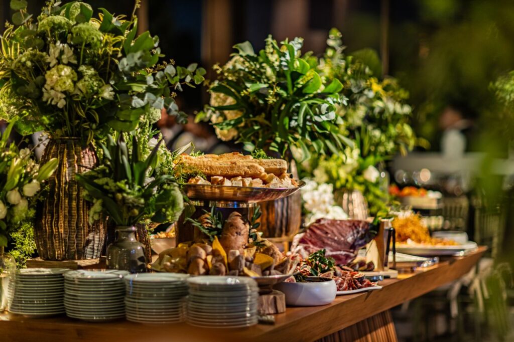 Beautifully decorated banquet table with flowers and assorted gourmet dishes.